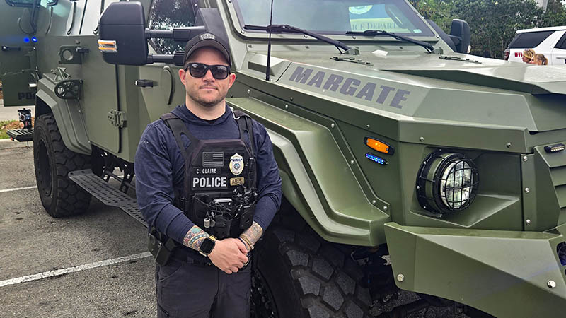 Casey Claire in front of the SWAT vehicle
